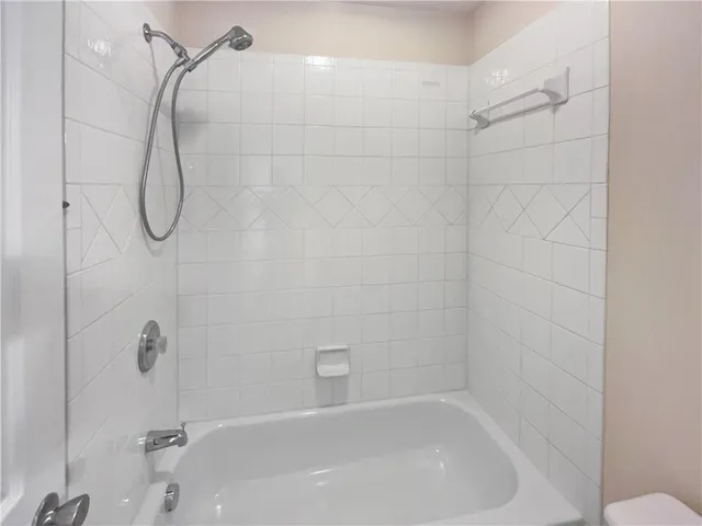 a bathroom with a bath tub with a shower