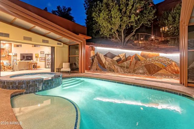 a swimming pool with outdoor seating and yard