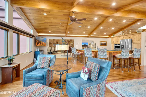 a living room with furniture a rug and a chandelier