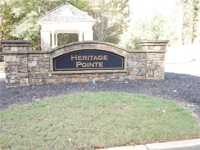 a front view of a house with yard tree and outdoor seating