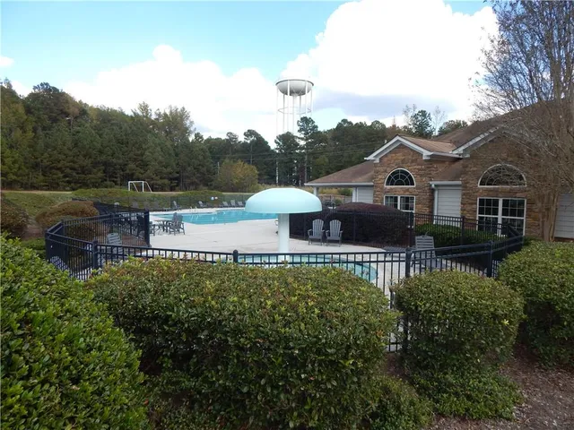 a view of a house with a yard and furniture