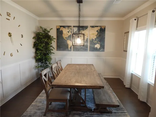 a view of a dining room with furniture and window