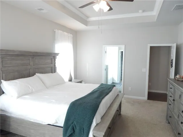 a bedroom with a bed and a flat tv screen