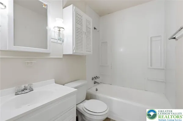 a bathroom with a sink a toilet and bathtub