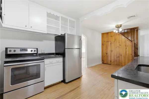 a kitchen with appliances cabinets and a counter top space