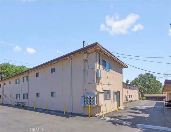 a front view of a house with plants