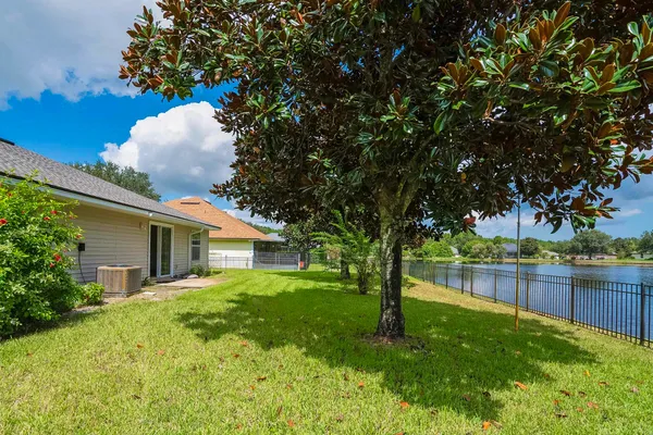 a backyard of a house with table and chairs