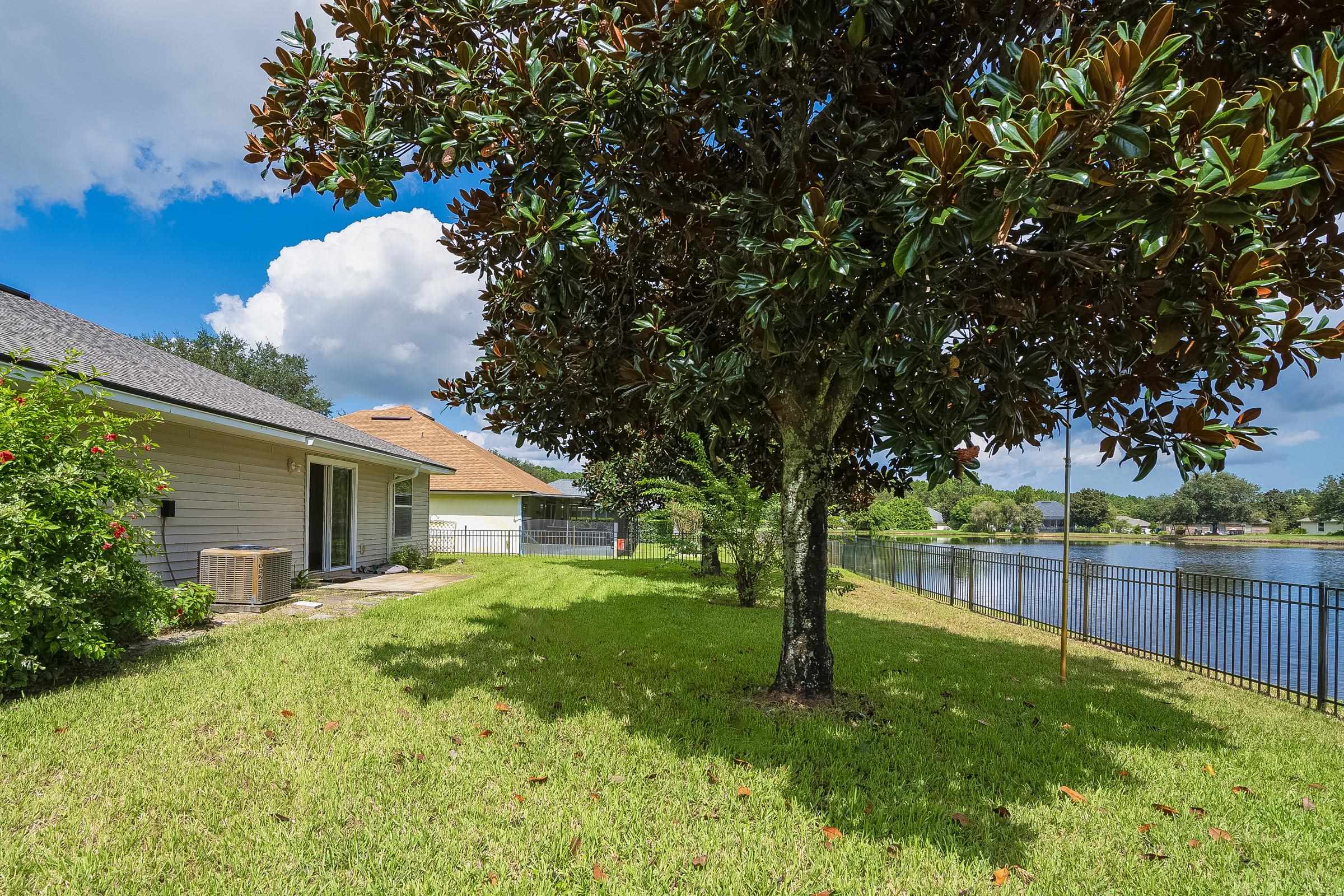 1732 South Summer Ridge Court St. Augustine, FL 32092 - Photo 13 of 42 a backyard of a house with table and chairs