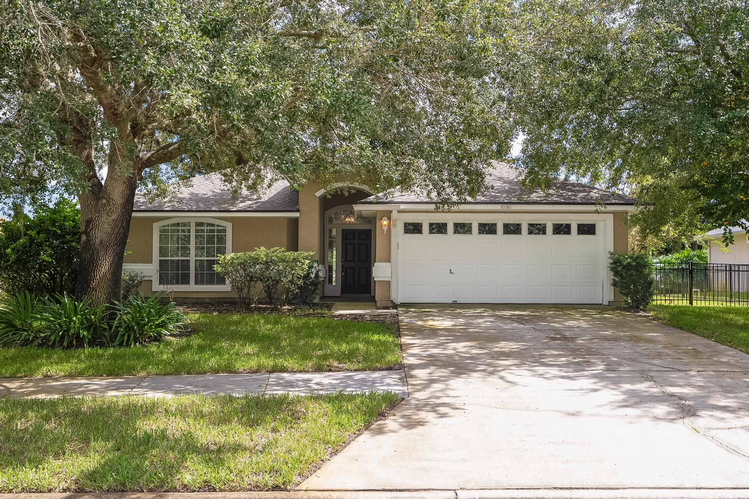 1732 South Summer Ridge Court St. Augustine, FL 32092 - Photo 2 of 42 a front view of a house with a yard garage and outdoor seating
