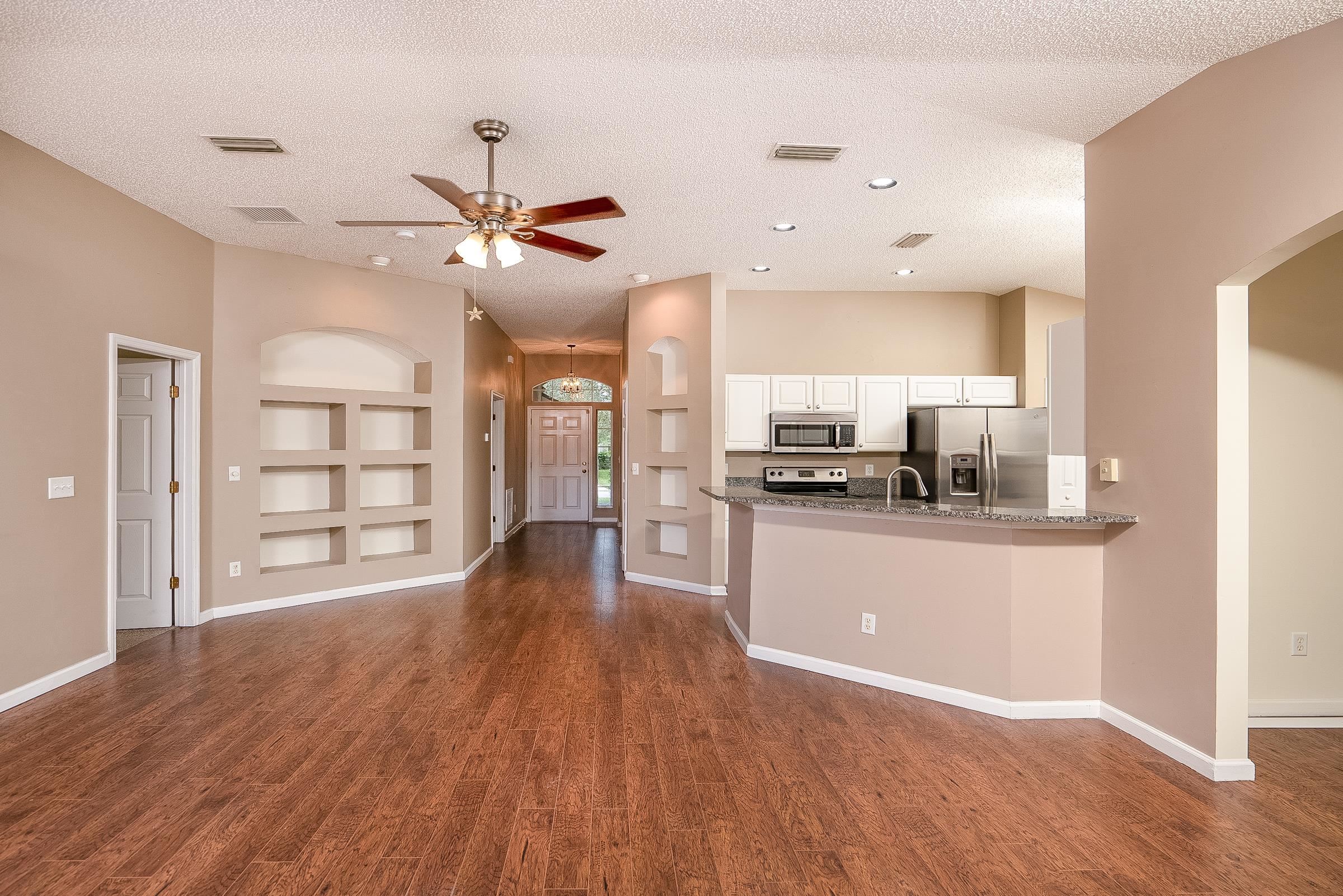 1732 South Summer Ridge Court St. Augustine, FL 32092 - Photo 24 of 42 a living room with stainless steel appliances kitchen island hardwood floor and a view of kitchen