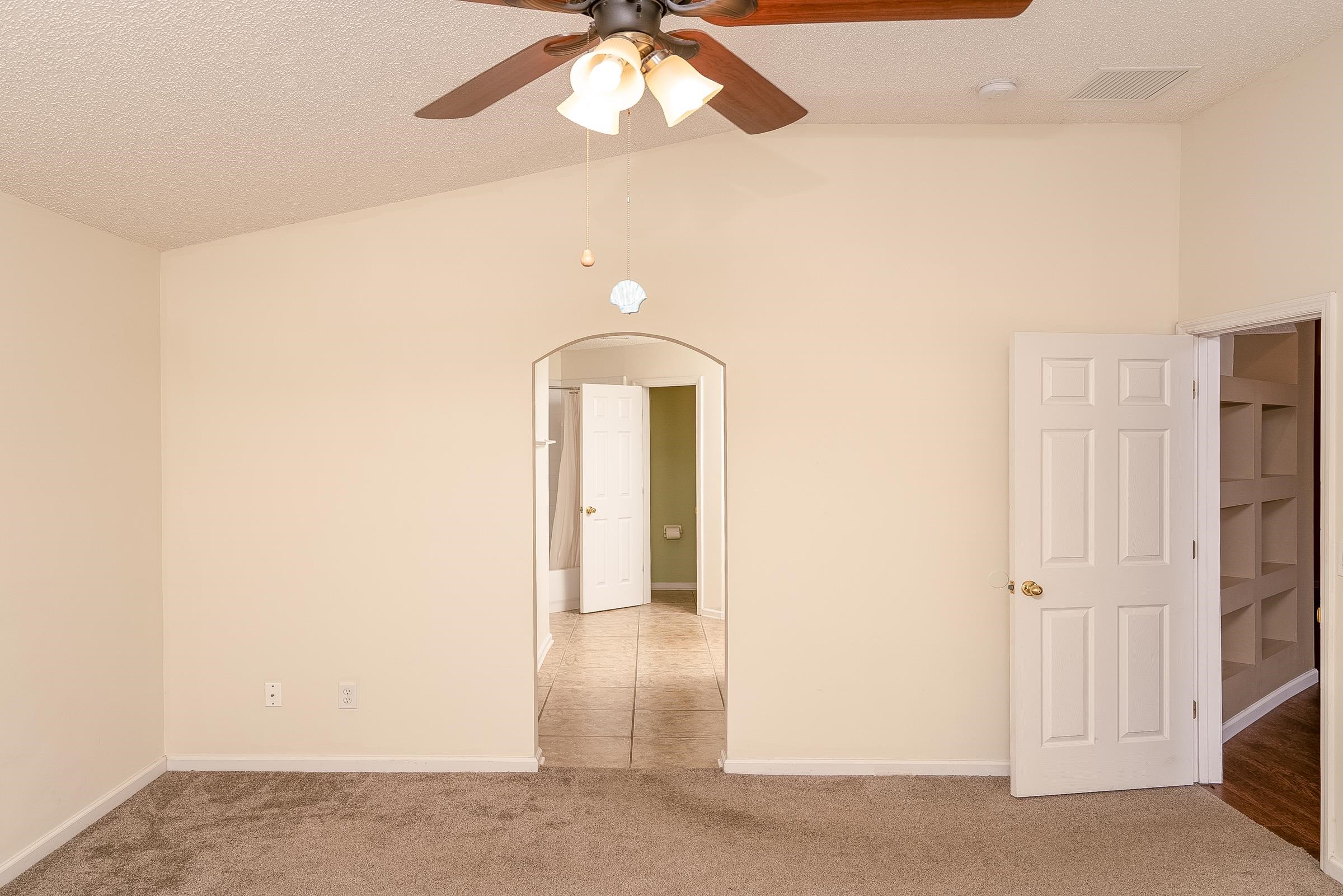 1732 South Summer Ridge Court St. Augustine, FL 32092 - Photo 26 of 42 an empty room with a chandelier fan and wooden floor