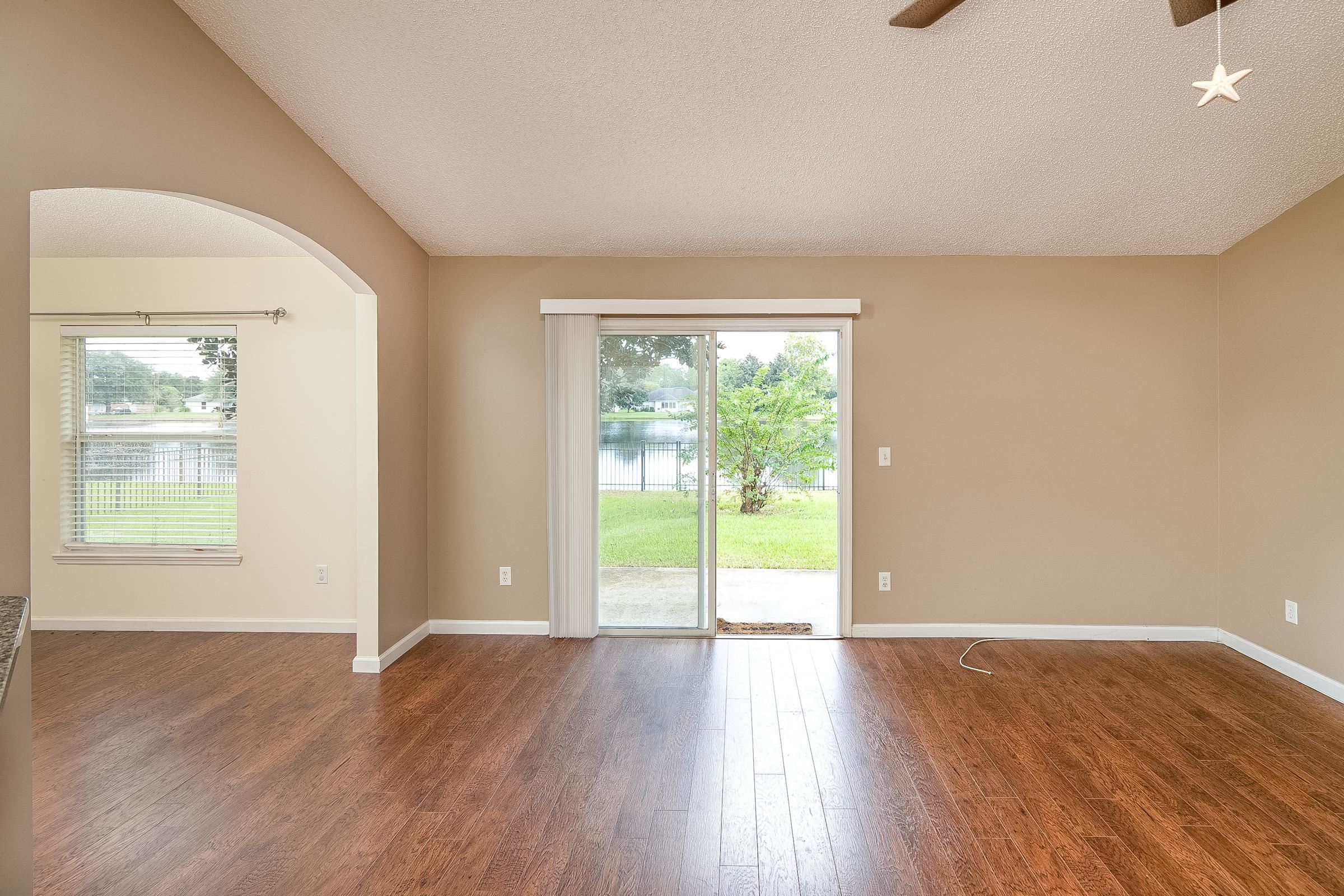 1732 South Summer Ridge Court St. Augustine, FL 32092 - Photo 9 of 42 a view of an empty room with wooden floor and a window