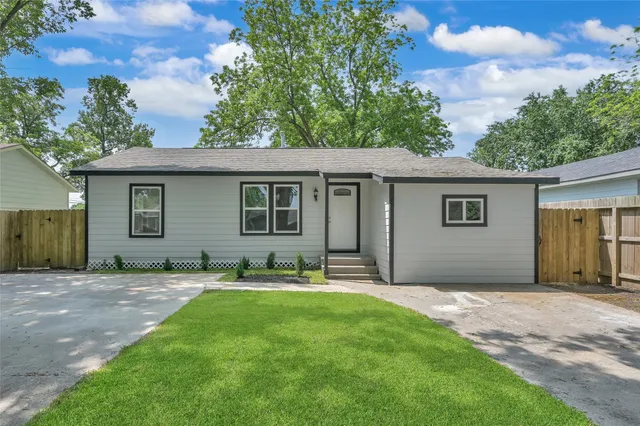 a backyard of a house with yard and barbeque oven
