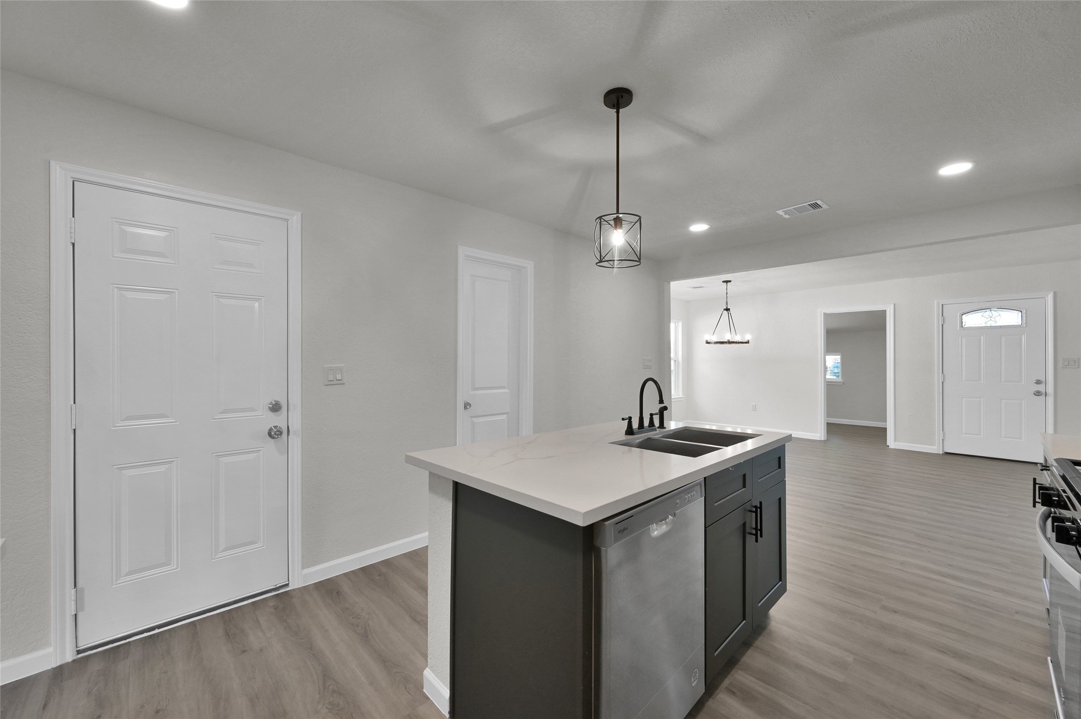 2826 Hopper Road Houston, TX 77093 - Photo 11 of 24 a kitchen with stainless steel appliances granite countertop a sink a stove and a wooden floors