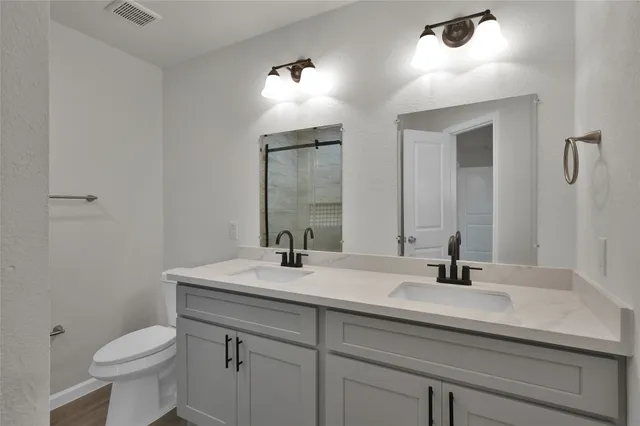 a bathroom with a sink toilet and mirror