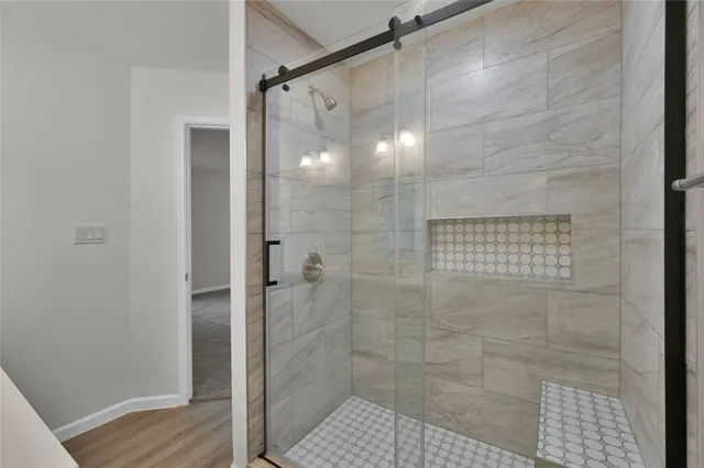 a bathroom with a glass door shower