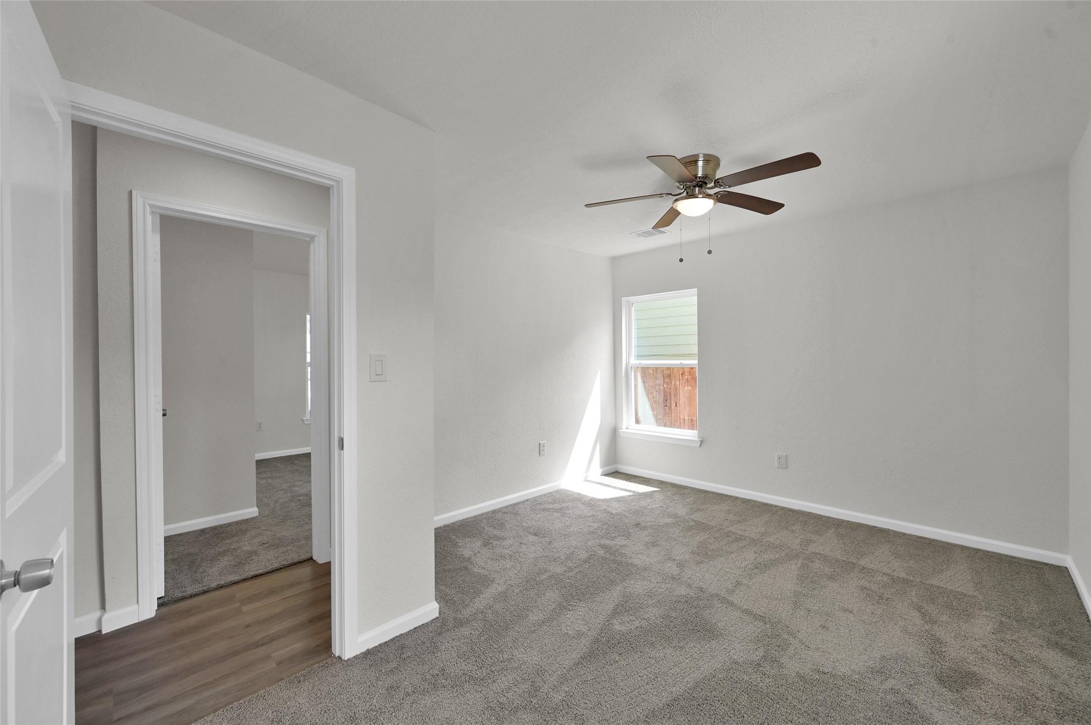 2826 Hopper Road Houston, TX 77093 - Photo 19 of 24 a view of empty room with wooden floor and ceiling fan