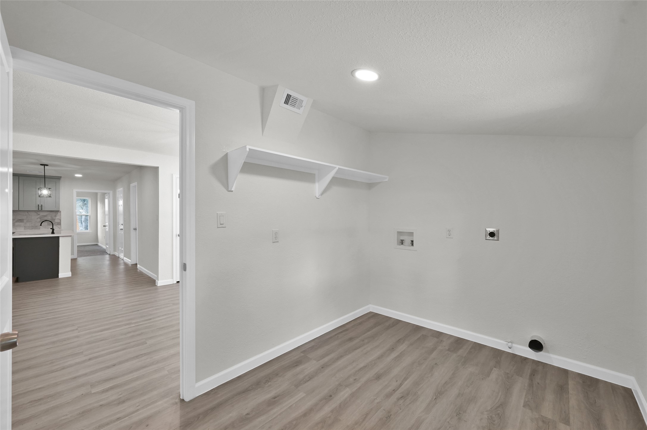 2826 Hopper Road Houston, TX 77093 - Photo 21 of 24 a view of an empty room with wooden floor