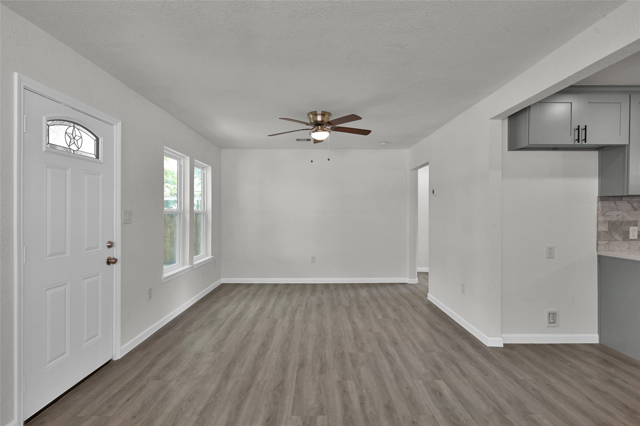 2826 Hopper Road Houston, TX 77093 - Photo 4 of 24 a view of an empty room with a window and wooden floor