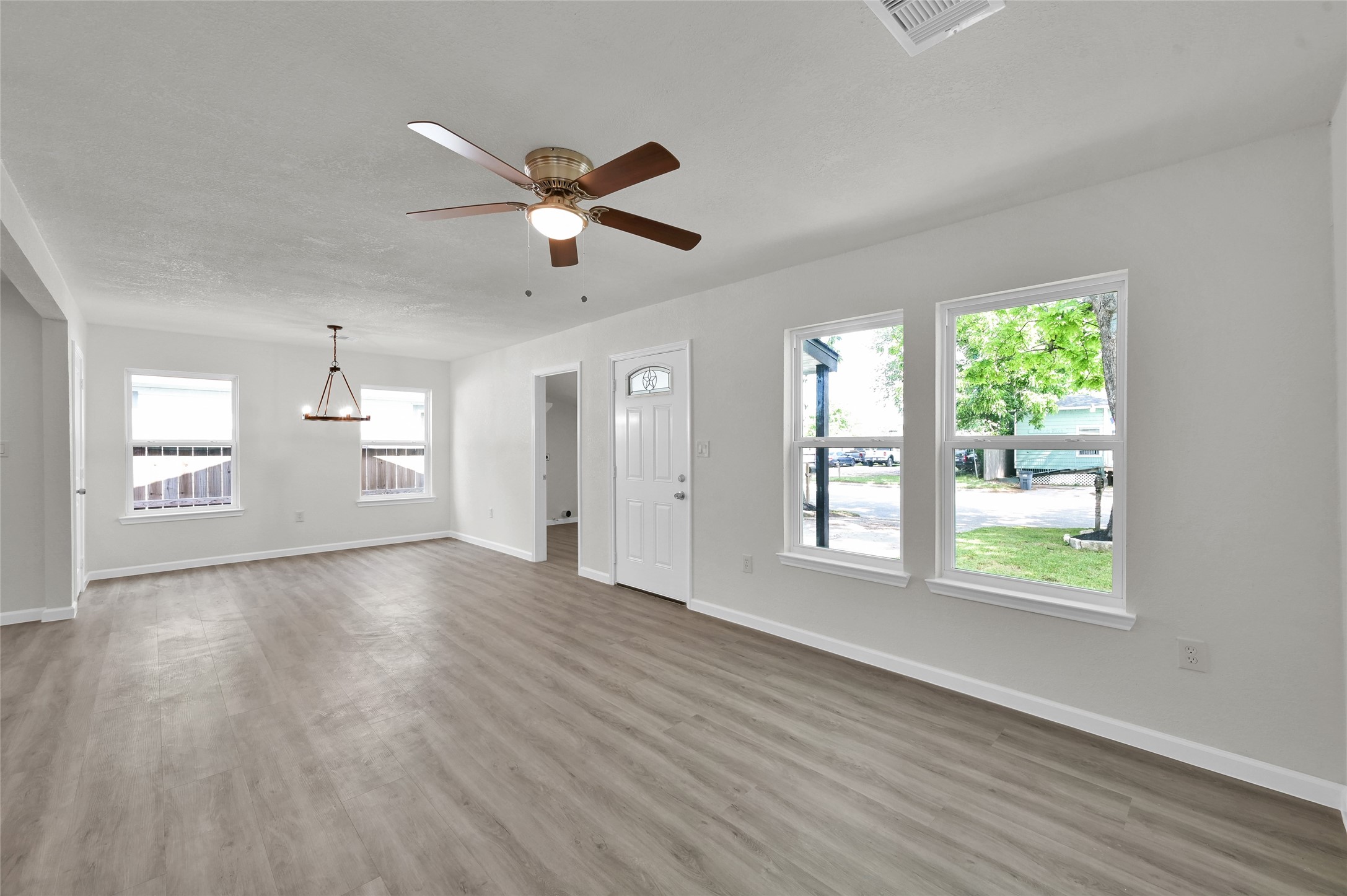 2826 Hopper Road Houston, TX 77093 - Photo 6 of 24 a view of an empty room with a window and wooden floor