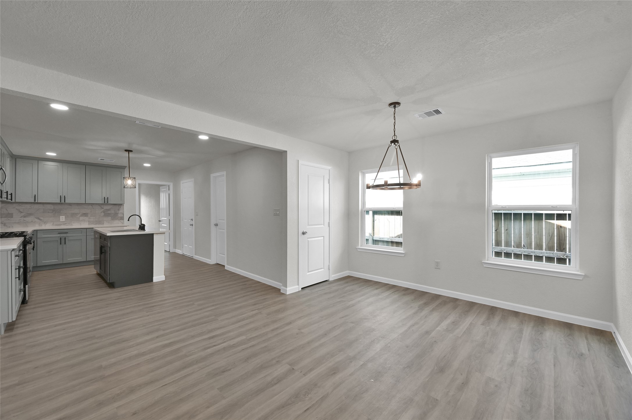 2826 Hopper Road Houston, TX 77093 - Photo 7 of 24 a view of an empty room with wooden floor and a window