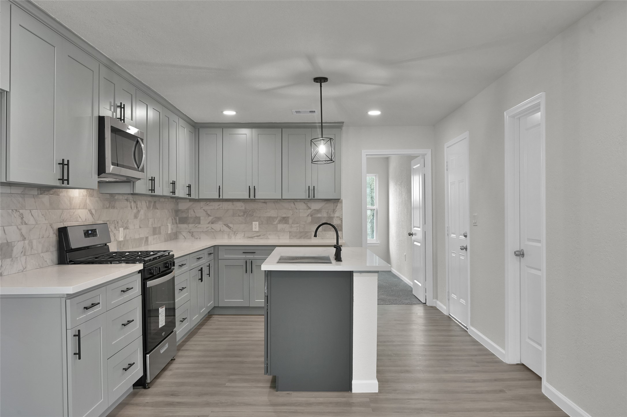 2826 Hopper Road Houston, TX 77093 - Photo 10 of 24 a kitchen with stainless steel appliances granite countertop a sink stove and refrigerator