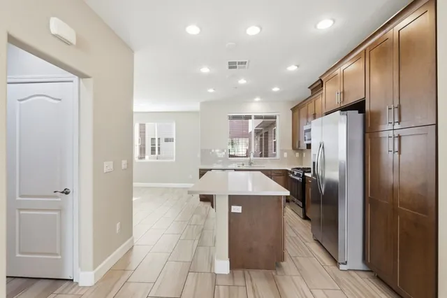 a kitchen with stainless steel appliances a sink stove and microwave
