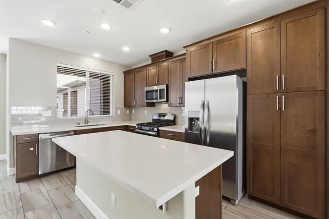 a view of kitchen with granite countertop cabinets and window