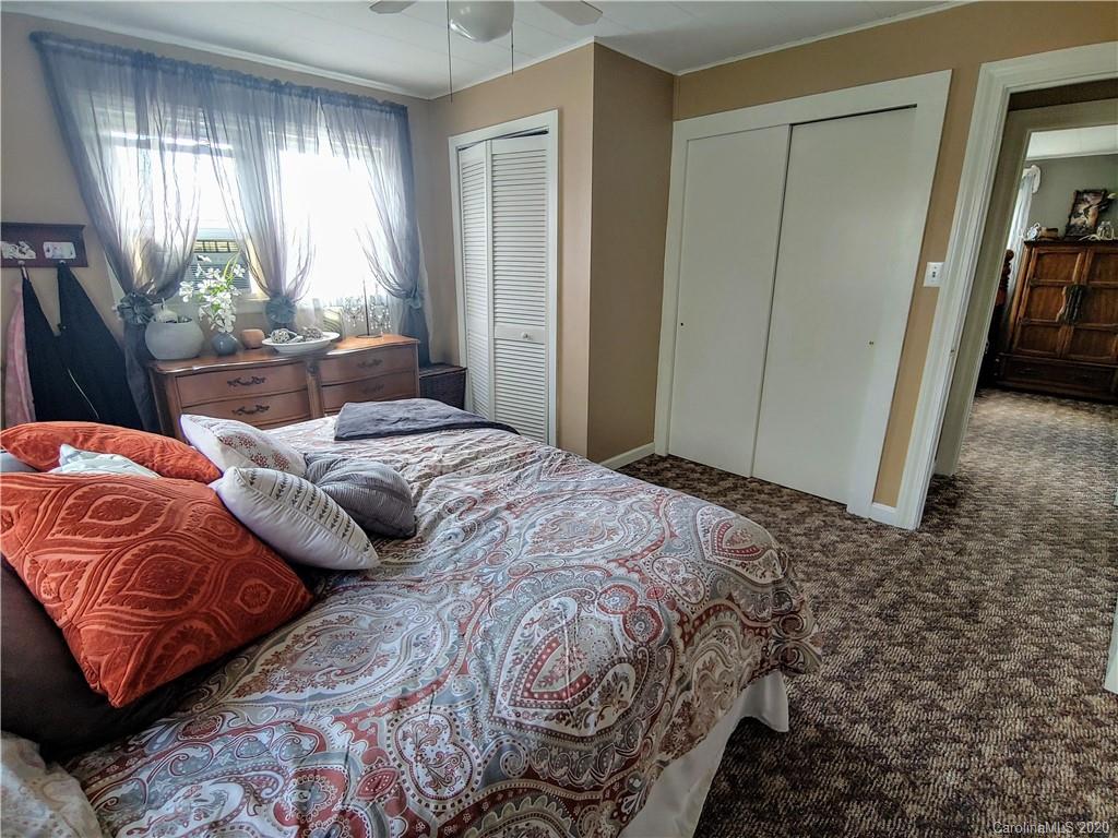 137 Thompson Cove Road Clyde, NC 28721 - Photo 22 of 46 a bedroom with bed and window