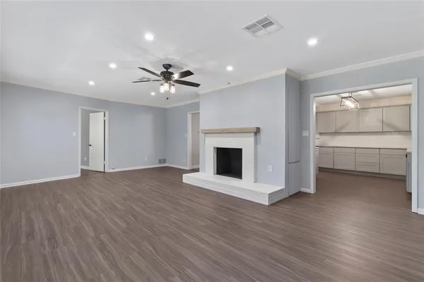 a view of an empty room with a fireplace and a window