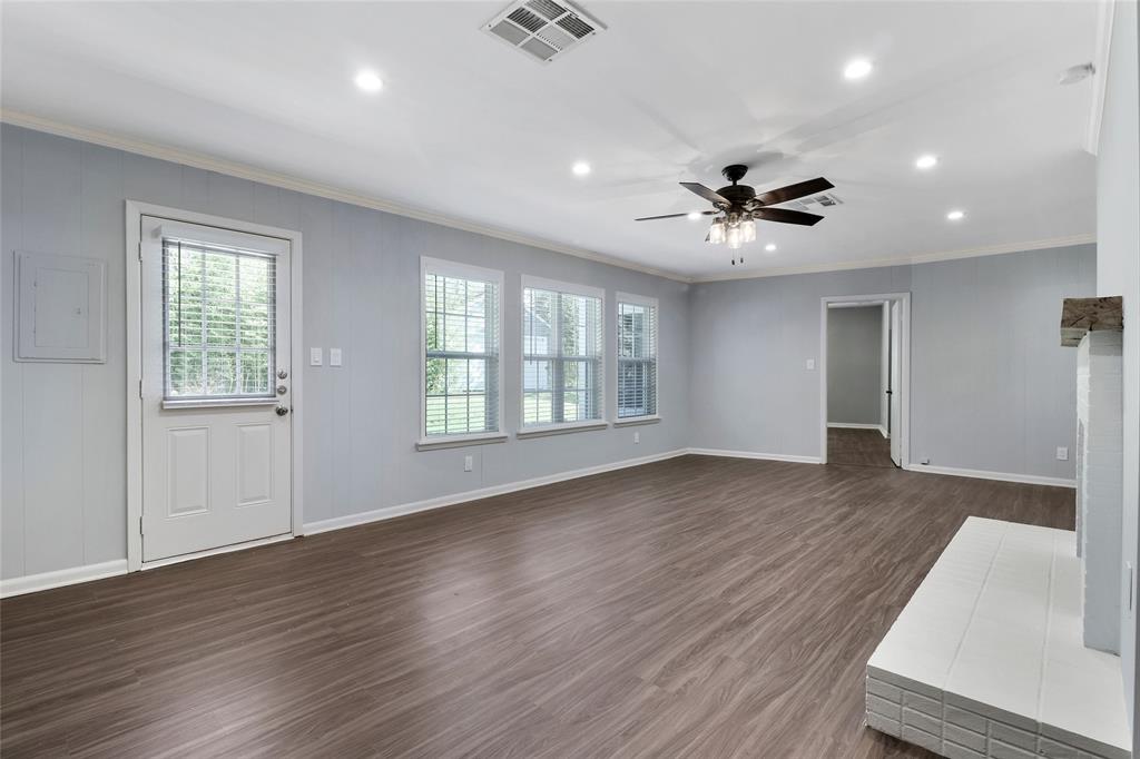3557 Winston Road Fort Worth, TX 76109 - Photo 12 of 25 a view of an empty room with window and wooden floor