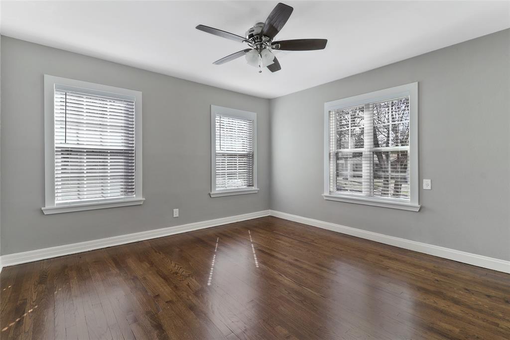 3557 Winston Road Fort Worth, TX 76109 - Photo 21 of 25 a view of an empty room with wooden floor and a window