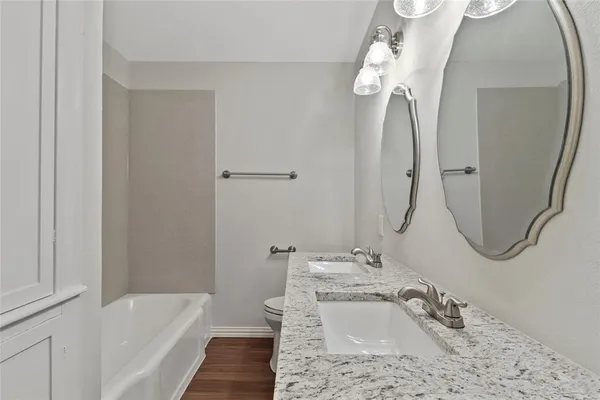 a bathroom with a sink a faucet a mirror and a bathtub