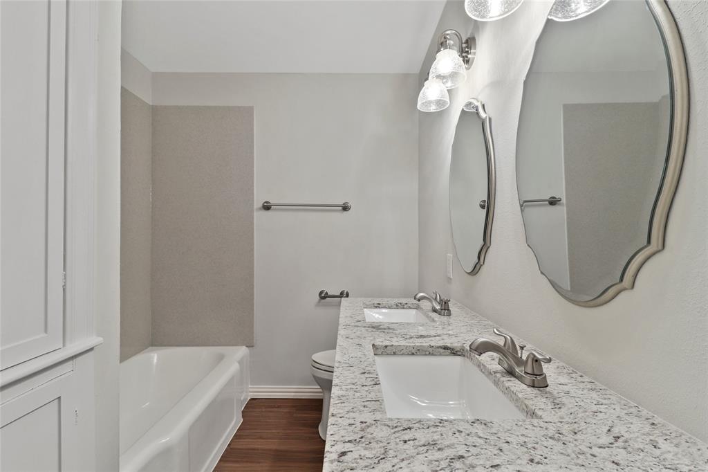 3557 Winston Road Fort Worth, TX 76109 - Photo 22 of 25 a bathroom with a sink a faucet a mirror and a bathtub