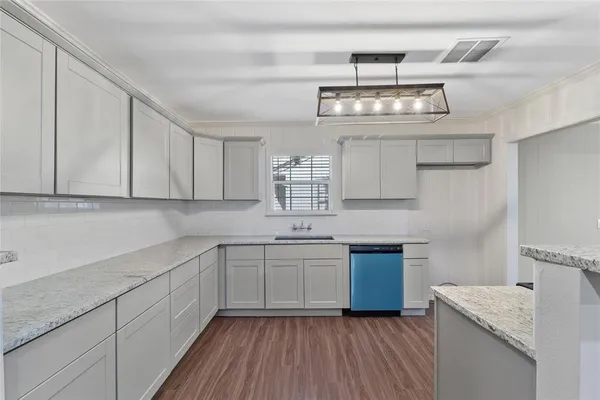 a kitchen with stainless steel appliances granite countertop a sink stove and cabinets