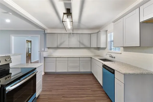 a kitchen with a sink stainless steel appliances and cabinets
