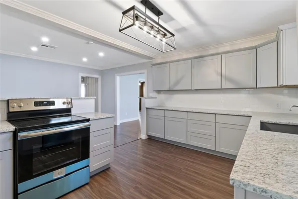 a kitchen with sink cabinets and stainless steel appliances