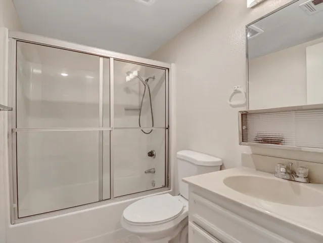 a bathroom with a toilet a sink and shower
