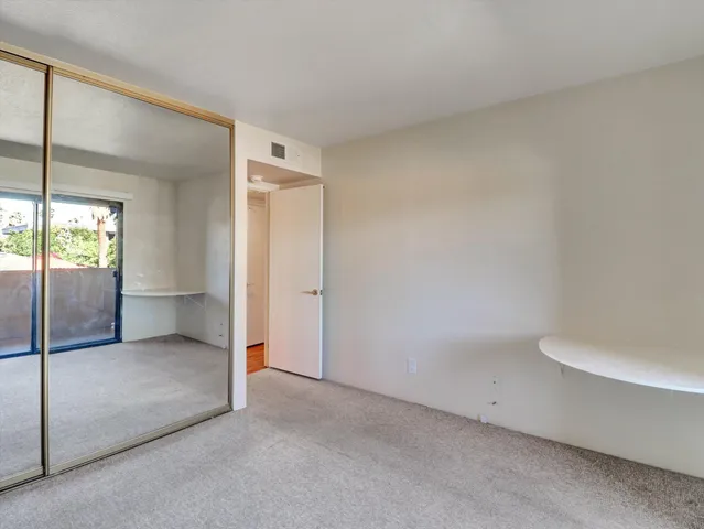 an empty room with sliding glass door