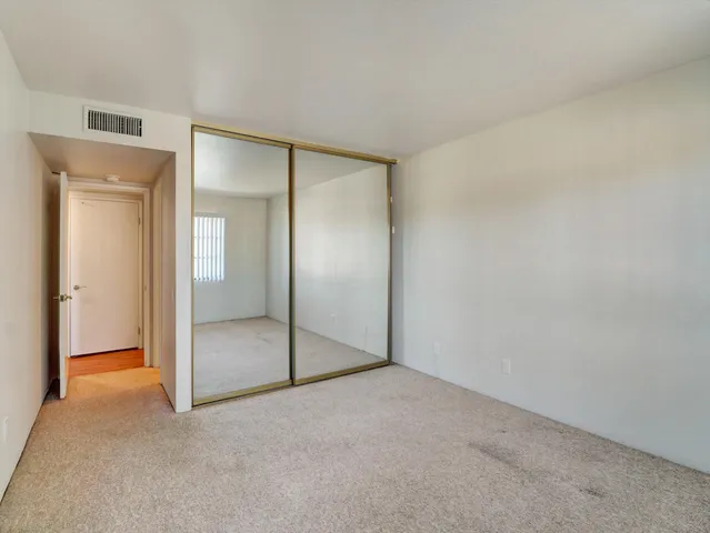 an empty room with mirror in closet