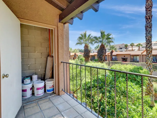 a view of a balcony with potted plants