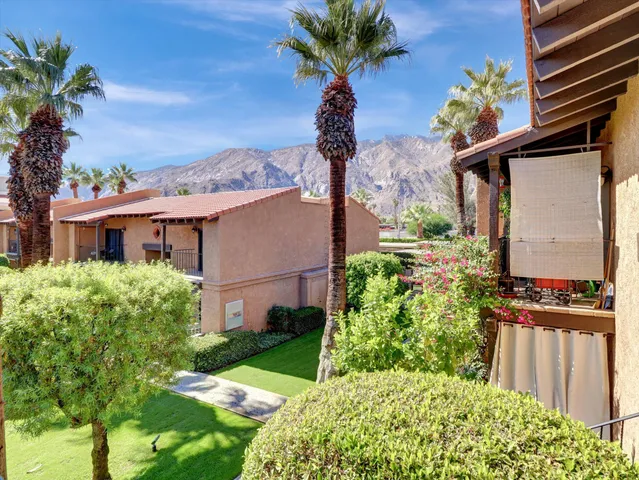 a view of a house with a flower garden