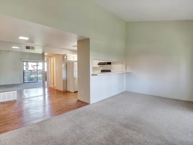 a view of a kitchen with a sink and a refrigerator