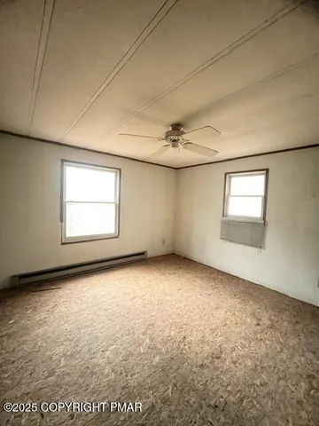 an empty room with a empty space and windows