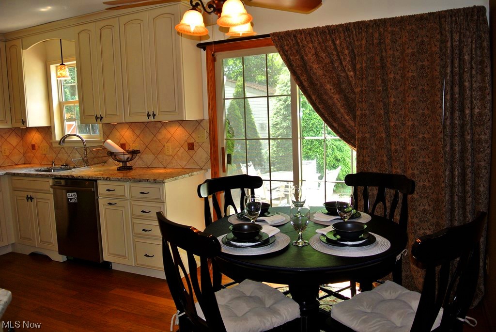 1804 Springfield Center Road Akron, OH 44312 - Photo 17 of 37 Dining area featuring sink, dark hardwood / wood-style flooring, and a notable chandelier
