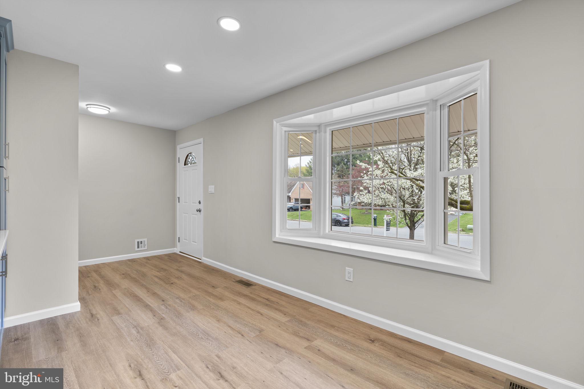 24320 Log House Road Gaithersburg, MD 20882 - Photo 15 of 43 an empty room with wooden floor and windows