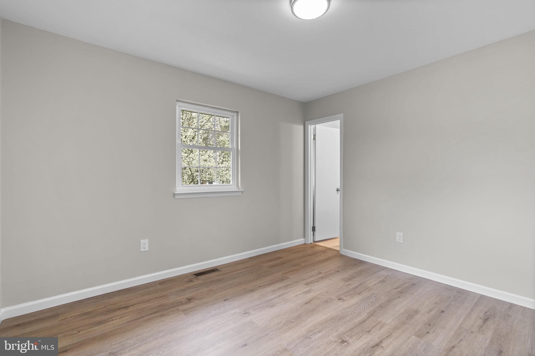 24320 Log House Road Gaithersburg, MD 20882 - Photo 18 of 43 an empty room with wooden floor and windows