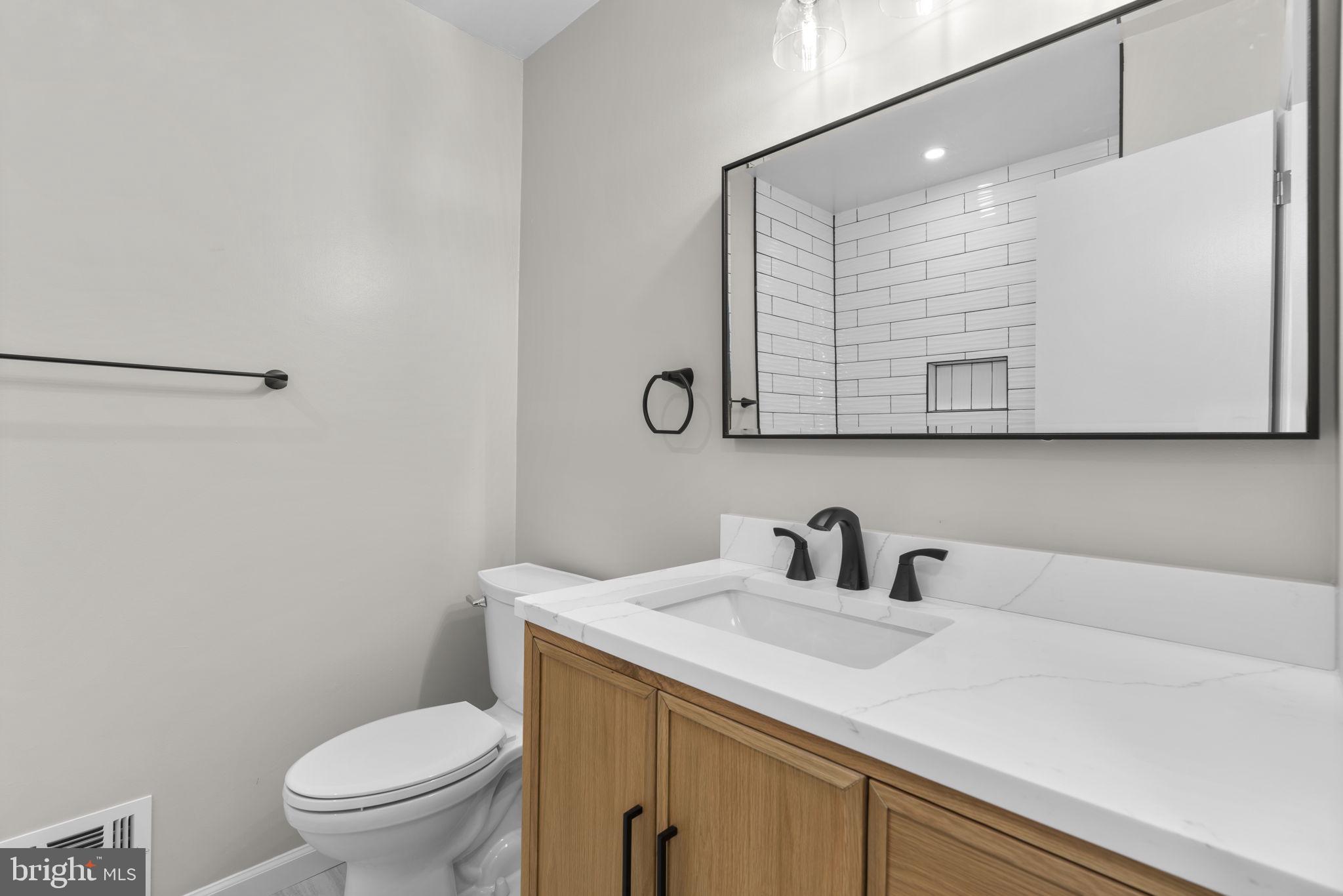 24320 Log House Road Gaithersburg, MD 20882 - Photo 25 of 43 a bathroom with a toilet sink and mirror