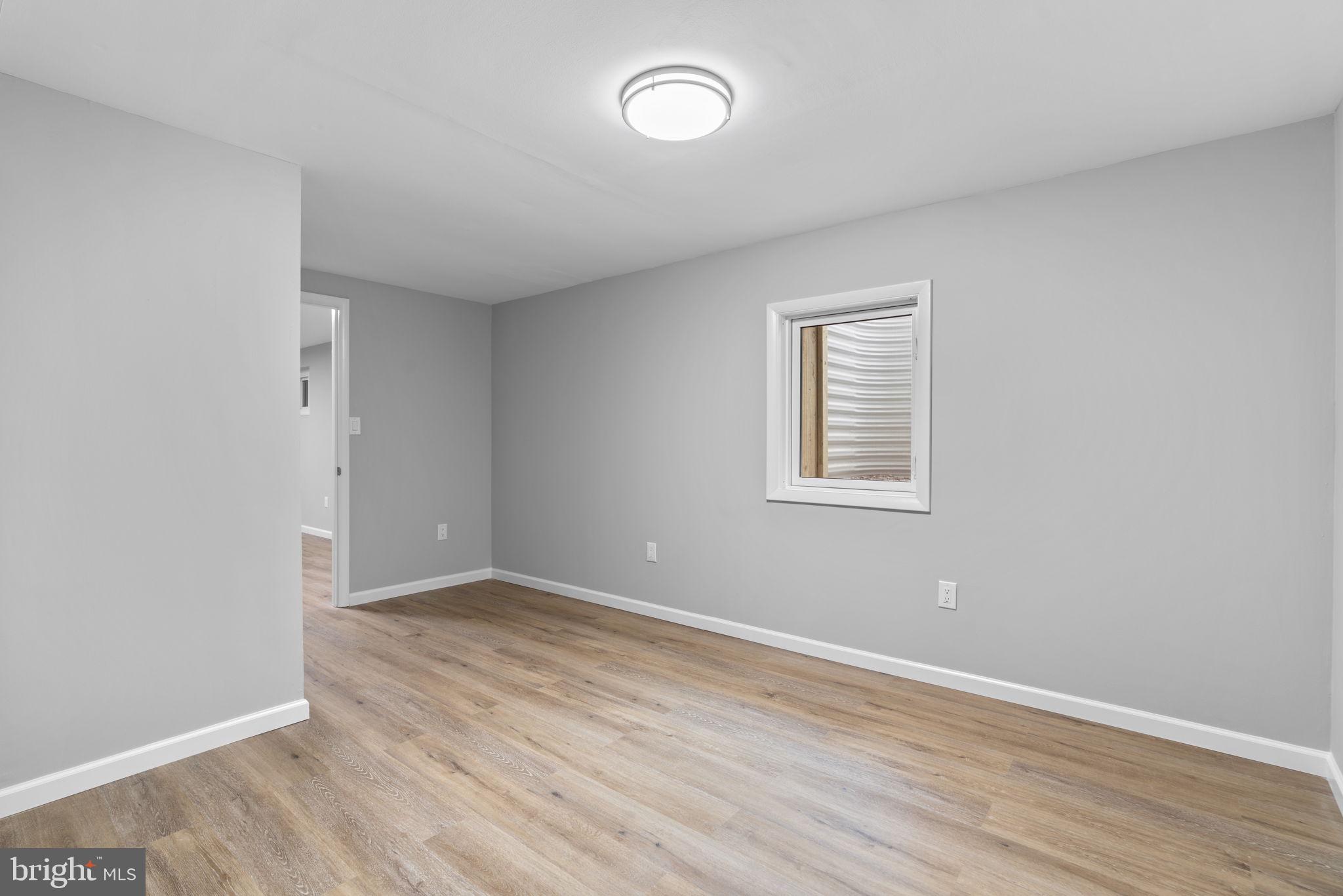 24320 Log House Road Gaithersburg, MD 20882 - Photo 32 of 43 an empty room with wooden floor and windows