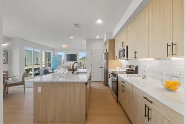 a large kitchen with stainless steel appliances lots of counter space and breakfast area
